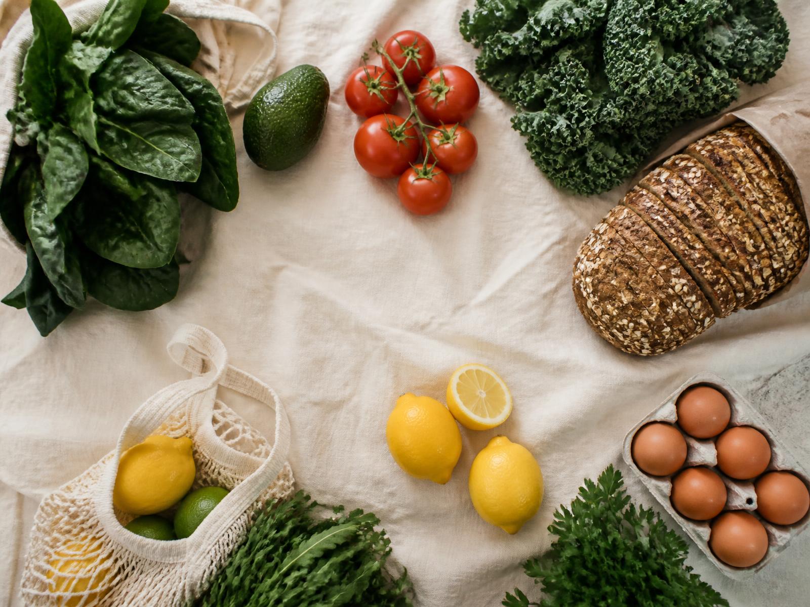 Fresh groceries arranged on a linen cloth